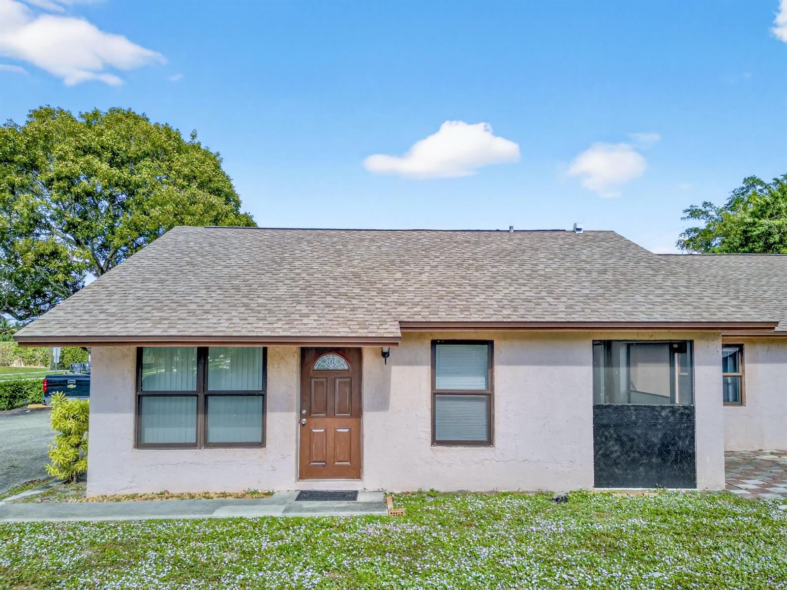 A single-story house with a brown roof, tan stucco walls, and a brown front door — 2548 Ida Way, West Palm Beach FL 33415, WEST PALM BEACH, FL