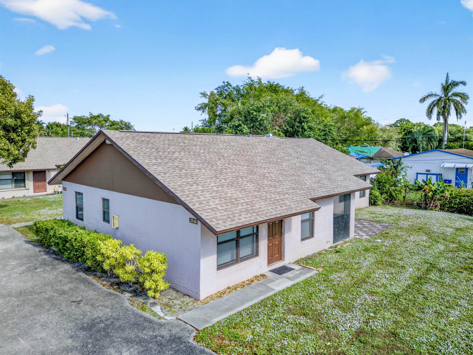 An aerial view shows a single-story house with a light-colored exterior and brown roof — 2548 Ida Way, West Palm Beach FL 33415, WEST PALM BEACH, FL