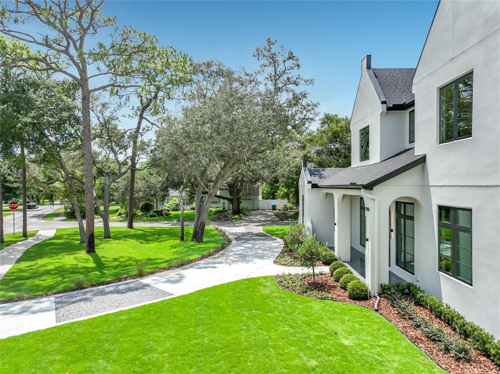 A white two-story house with a curved concrete driveway and a large grassy front yard — 2905 PARKLAND DRIVE, WINTER PARK, FL