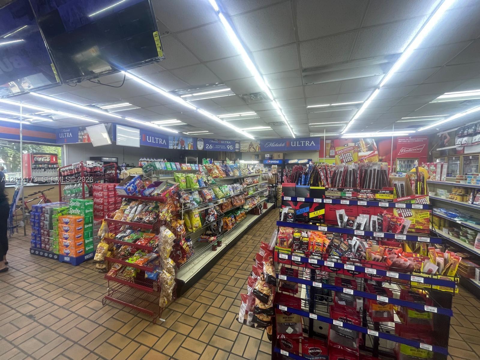 The interior of a convenience store features aisles stocked with snacks and beverages — 895 N Nova, Daytona FL 32117, DAYTONA, FL
