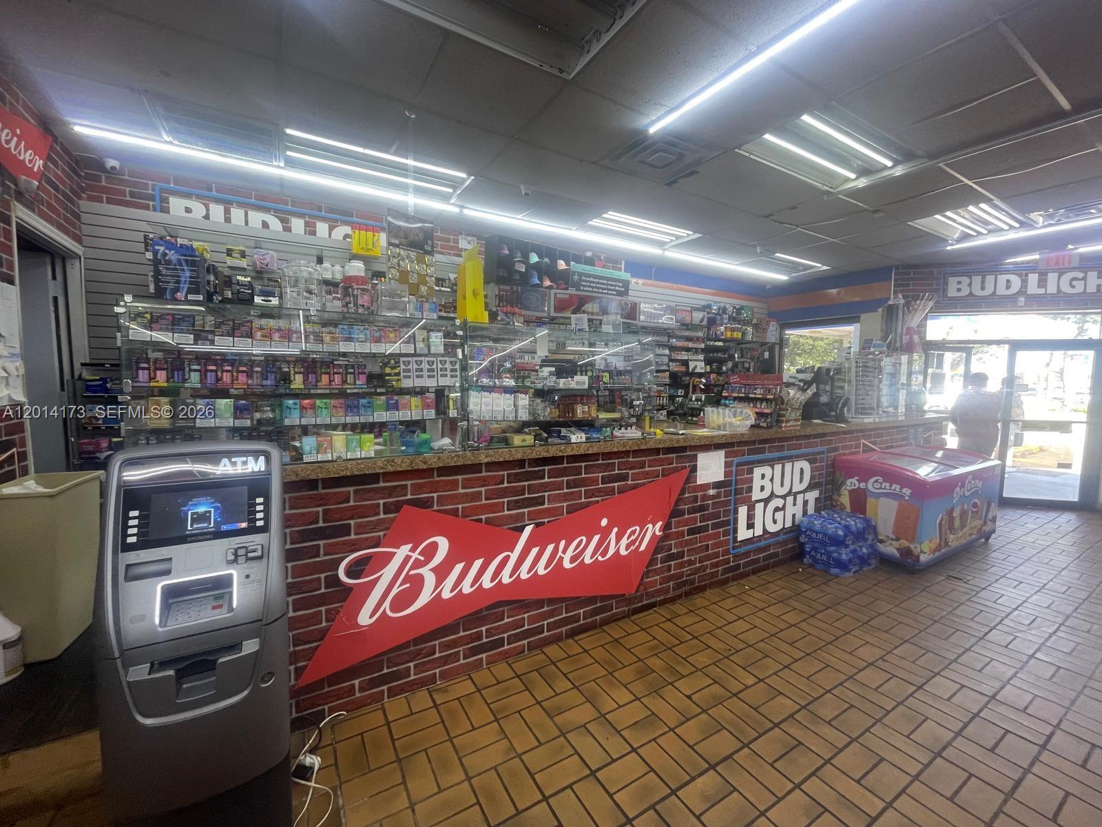 A retail store interior features a brick-front service counter, an ATM, and product shelving — 895 N Nova, Daytona FL 32117, DAYTONA, FL