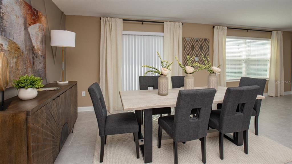 A dining room features a wooden table with six dark gray chairs and a sideboard — 5240 WORCHESTER DRIVE, KISSIMMEE, FL