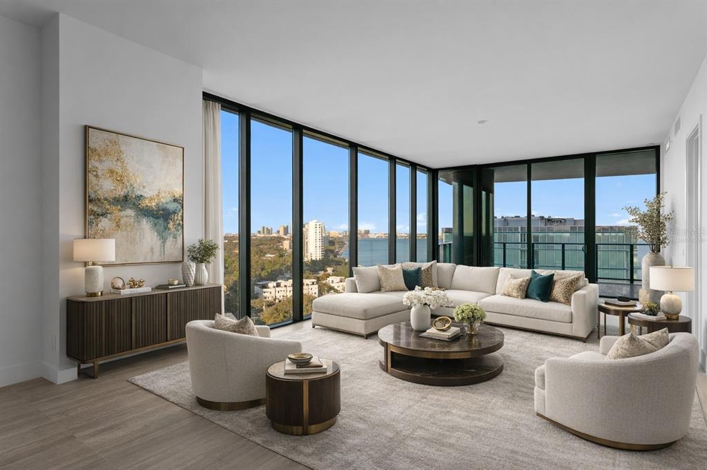 A modern living room features floor-to-ceiling windows with water views, neutral furniture, and wood flooring — 3015 S YSABELLA AVENUE UNIT 1601, TAMPA, FL