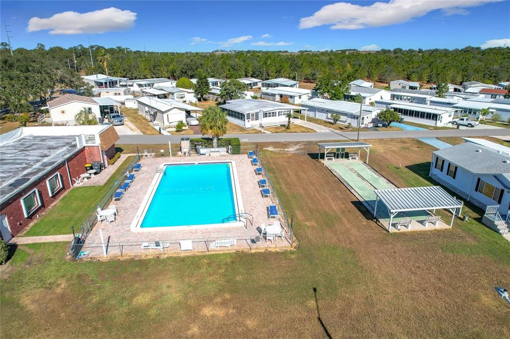 An aerial view shows a community swimming pool and shuffleboard court surrounded by mobile homes — 347 EDGEWOOD BOULEVARD, LAKE WALES, FL