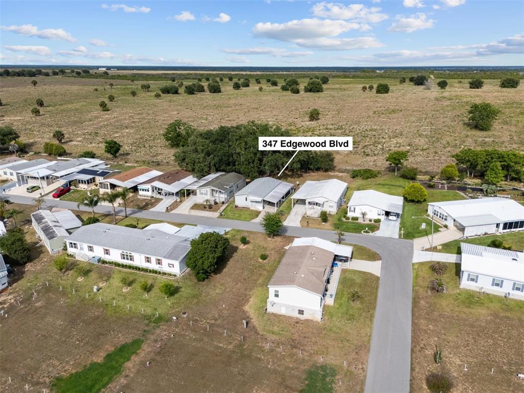 An aerial view shows a residential street with several manufactured homes and surrounding open land — 347 EDGEWOOD BOULEVARD, LAKE WALES, FL