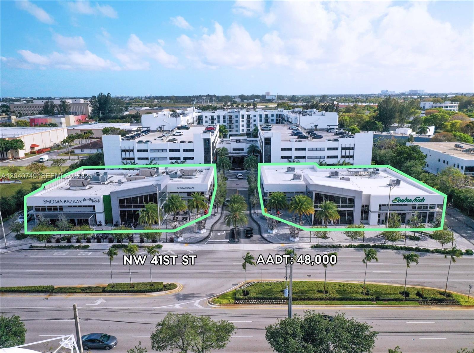 An aerial view shows two modern commercial buildings flanking a central driveway on a street — 9420 NW 41st St # 2, Doral FL 33178, DORAL, FL