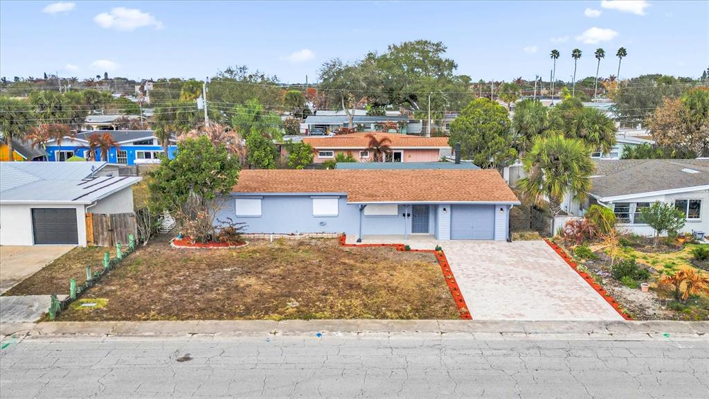 An aerial view of a single-story blue house with a brown roof and paved driveway — 290 PATRICK AVENUE, MERRITT ISLAND, FL