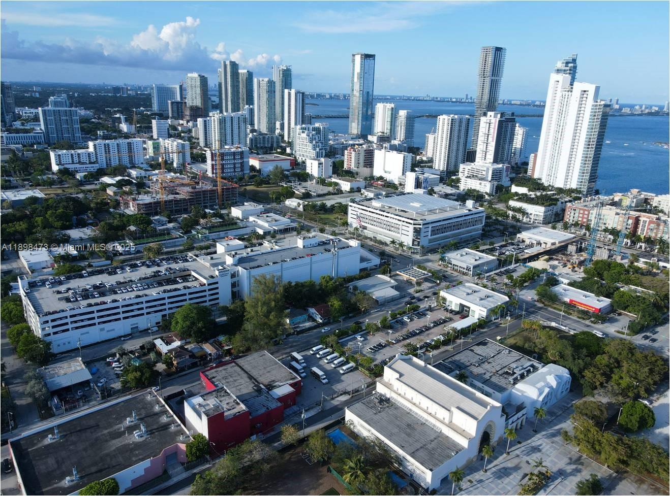 An aerial view of a dense urban cityscape featuring high-rise buildings and parking structures — 101 NE 20th St, Miami FL 33137, MIAMI, FL