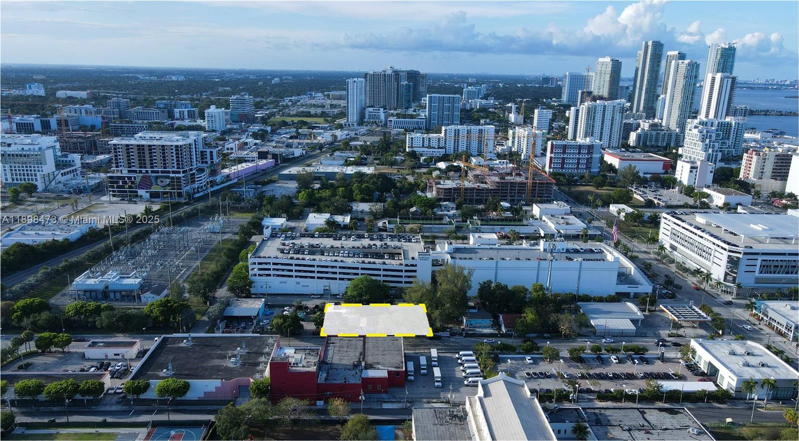 An aerial view shows a vacant rectangular lot highlighted in yellow amidst an urban landscape — 101 NE 20th St, Miami FL 33137, MIAMI, FL