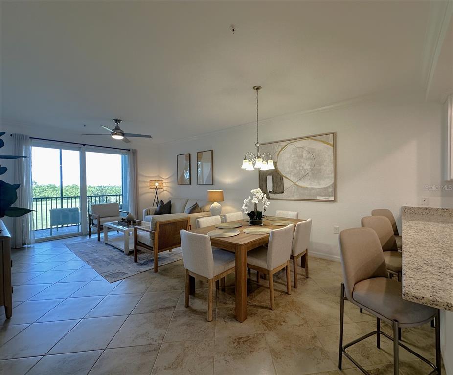 An open-concept living and dining area features tile flooring, a balcony, and neutral furniture — 14071 HERITAGE LANDING BOULEVARD UNIT 325, PUNTA GORDA, FL