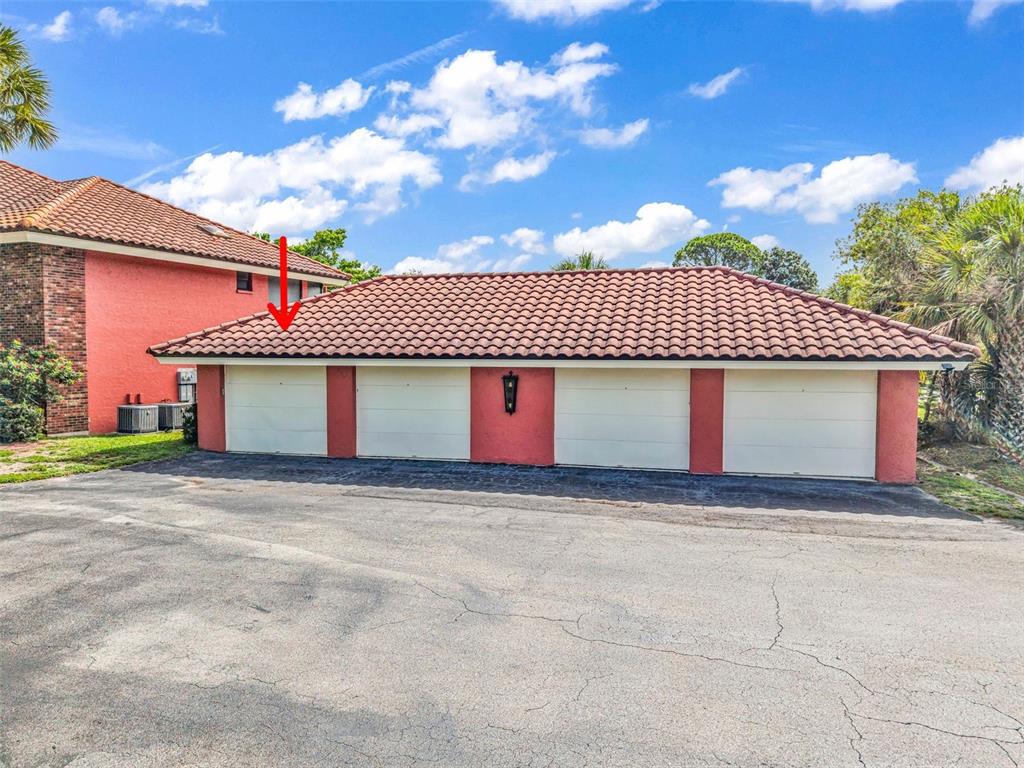 A detached four-car garage with a red tile roof and stucco exterior — 3013 CLARK ROAD UNIT 6, SARASOTA, FL