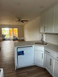 A kitchen with white cabinets and a dishwasher overlooks a living area with a balcony — 9272 SW 3rd St # 413, Boca Raton FL 33428, BOCA RATON, FL