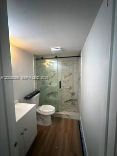 A bathroom features a white vanity, a toilet, and a glass-enclosed shower with marble-patterned tiles — 9272 SW 3rd St # 413, Boca Raton FL 33428, BOCA RATON, FL