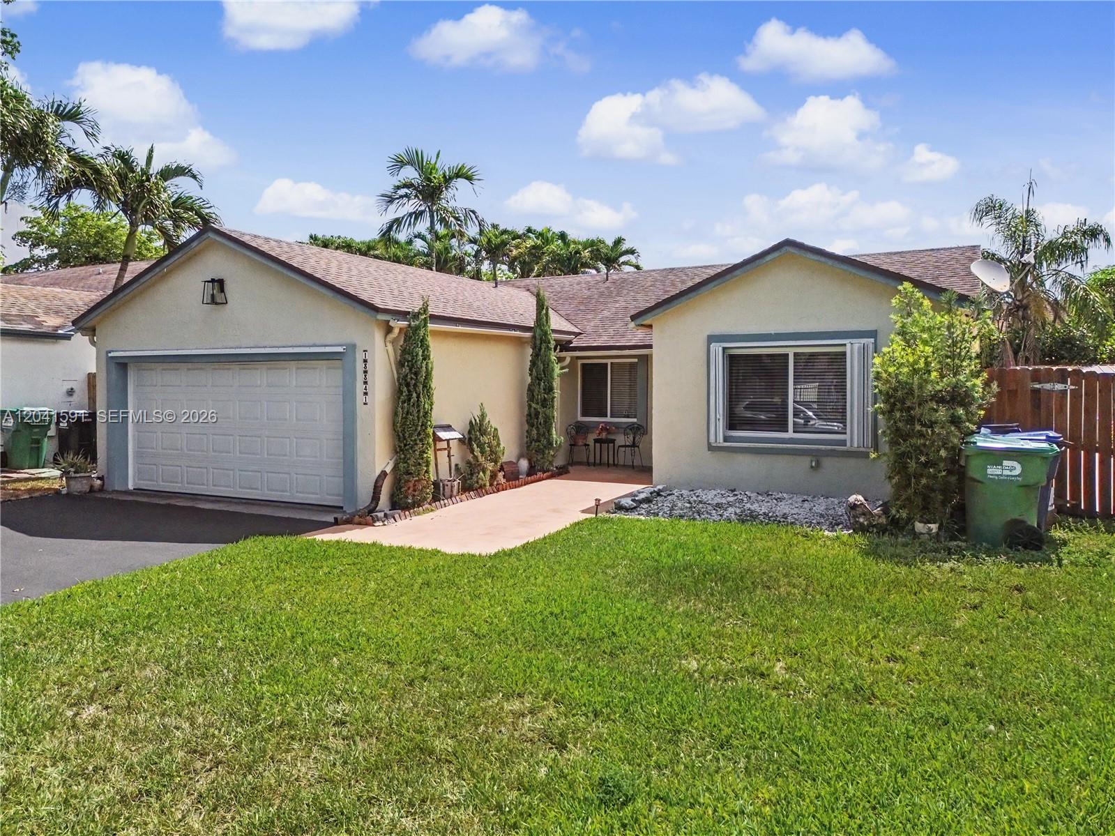 A single-story house with a garage, a front lawn, and a paved walkway — 13341 SW 114th Pl, Miami FL 33176, MIAMI, FL