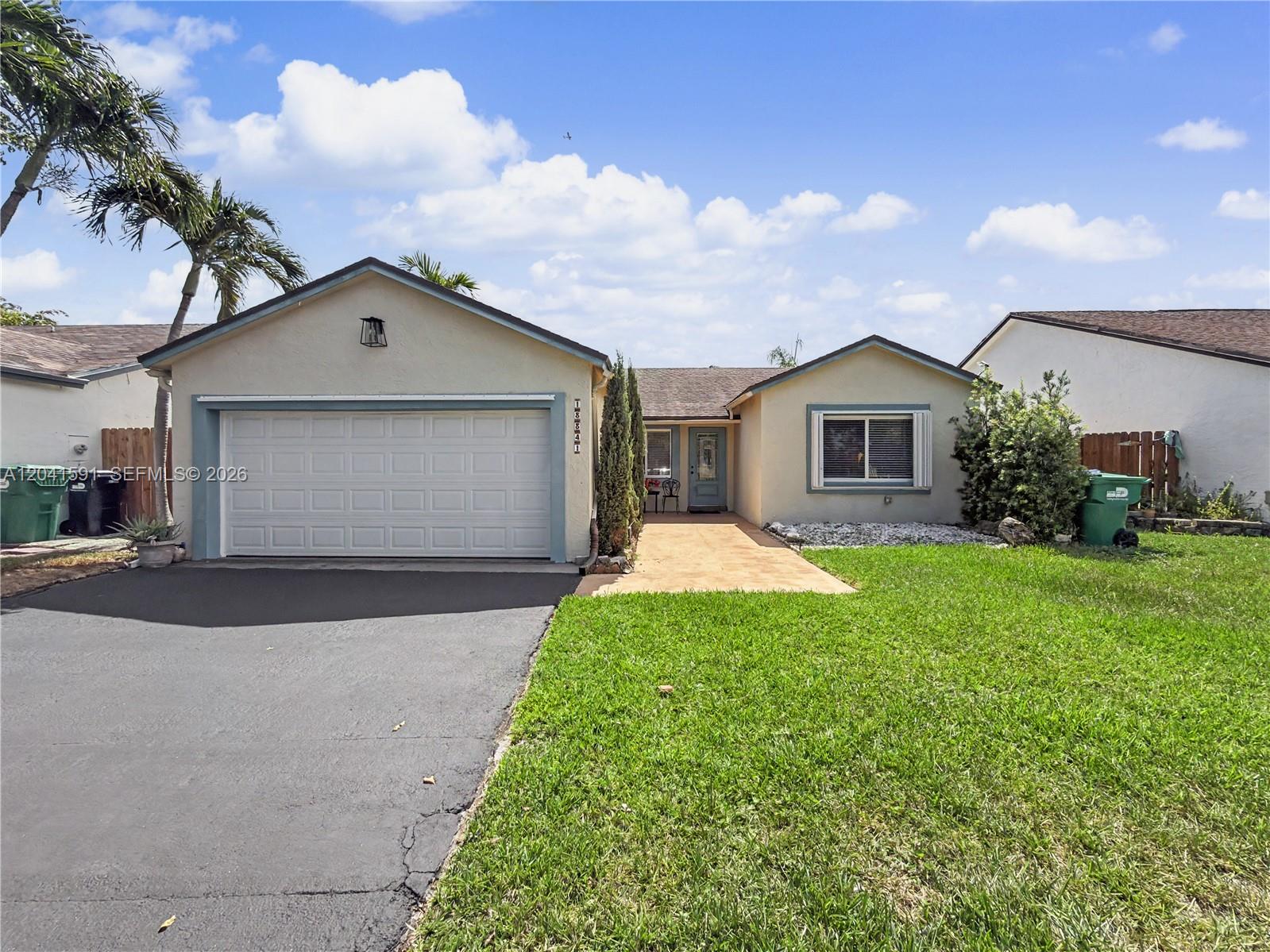 A single-story house features a garage, a paved walkway, and a green lawn — 13341 SW 114th Pl, Miami FL 33176, MIAMI, FL