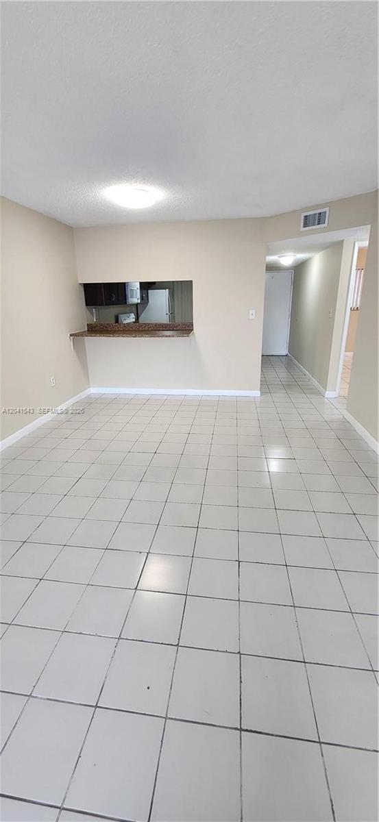 A parking lot sits in front of a multi-story white apartment building — 9915 W Okeechobee Rd # 404, Hialeah Gardens FL 33016, HIALEAH GARDENS, FL