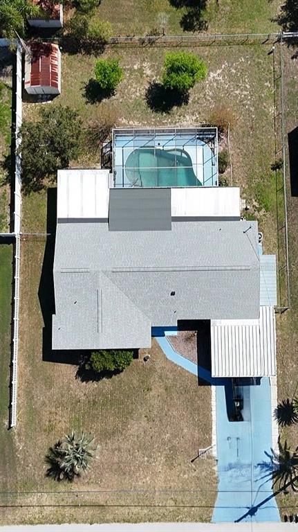 An aerial view shows a house with a screened-in pool, a carport, and a fenced yard — 2128 LINWOOD AVENUE, SPRING HILL, FL