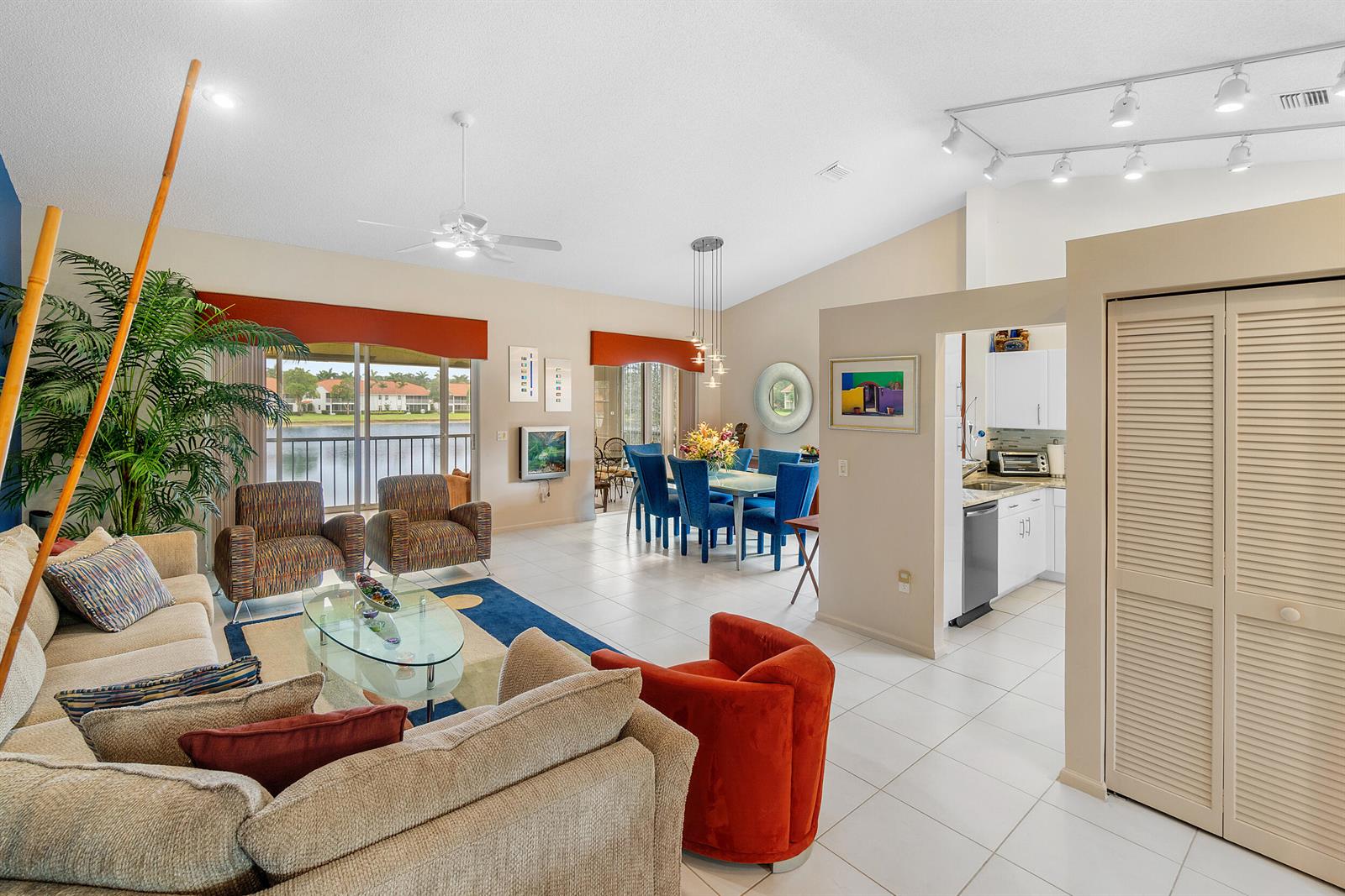 A living room and dining area with tile floors, a kitchen, and a lake view — 9829 Seacrest Circle # 202, Boynton Beach FL 33437, BOYNTON BEACH, FL