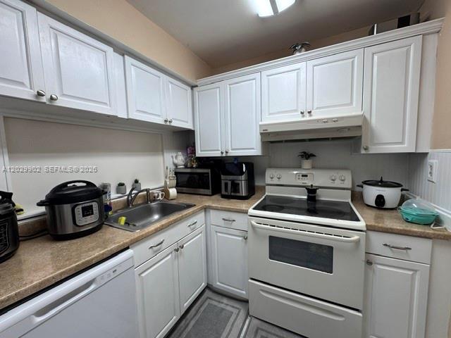 A kitchen features white cabinets, a stainless steel sink, and white appliances — 11780 SW 18th St # 2, Miami FL 33175, MIAMI, FL