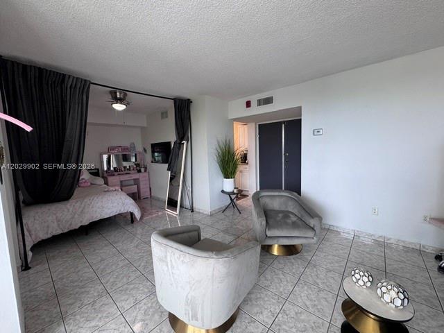 A bedroom area with a bed and vanity is separated from a living space by curtains — 11780 SW 18th St # 2, Miami FL 33175, MIAMI, FL