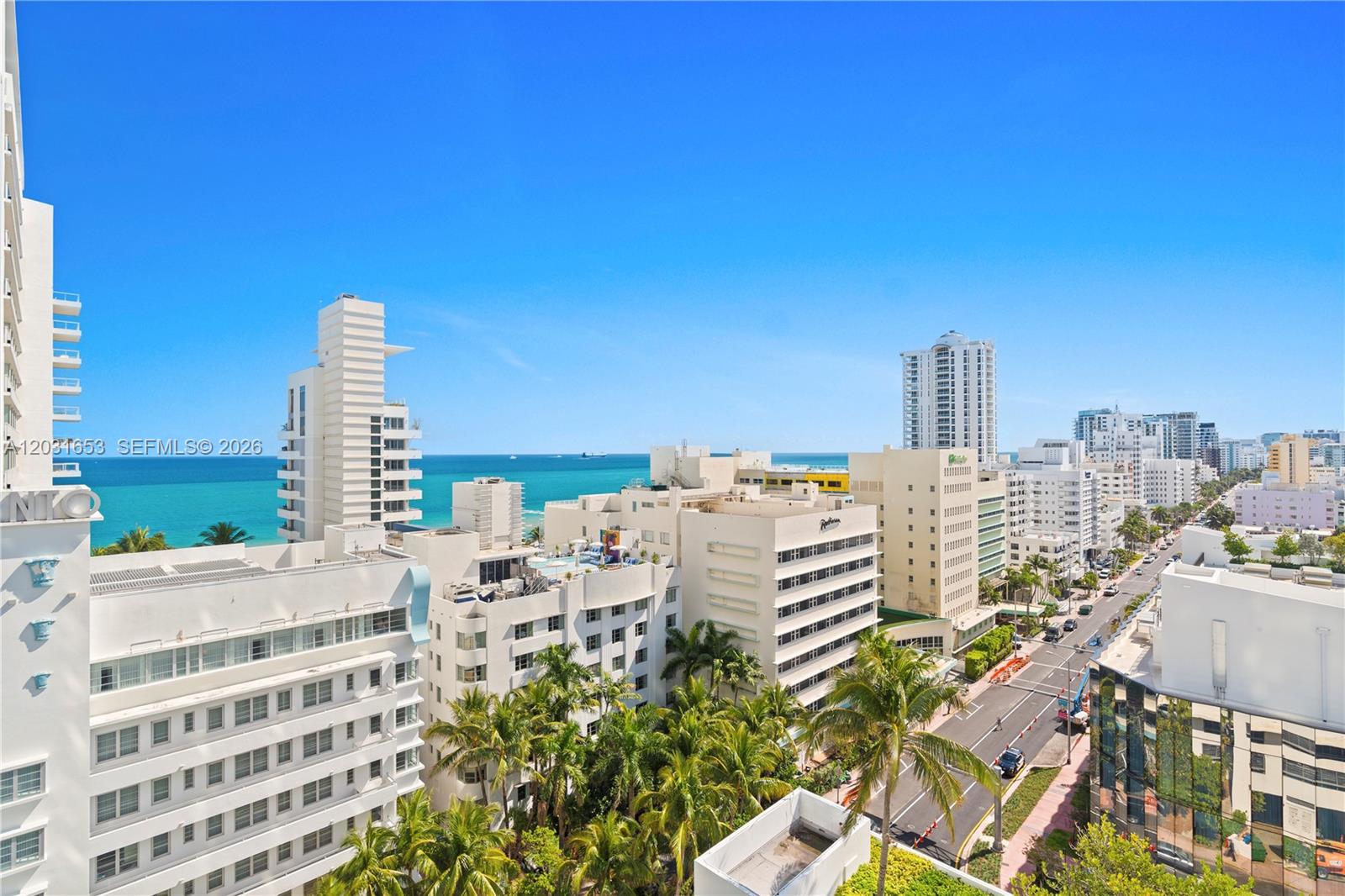 An elevated view shows a coastal city street lined with white buildings and palm trees — 4401 COLLINS AV # 1206, Miami Beach FL 33140, MIAMI BEACH, FL