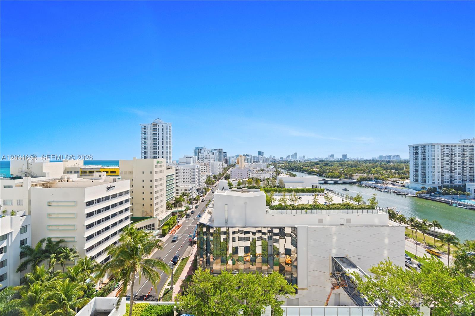 An elevated view shows a city street, a canal, and surrounding buildings under a clear sky — 4401 COLLINS AV # 1206, Miami Beach FL 33140, MIAMI BEACH, FL
