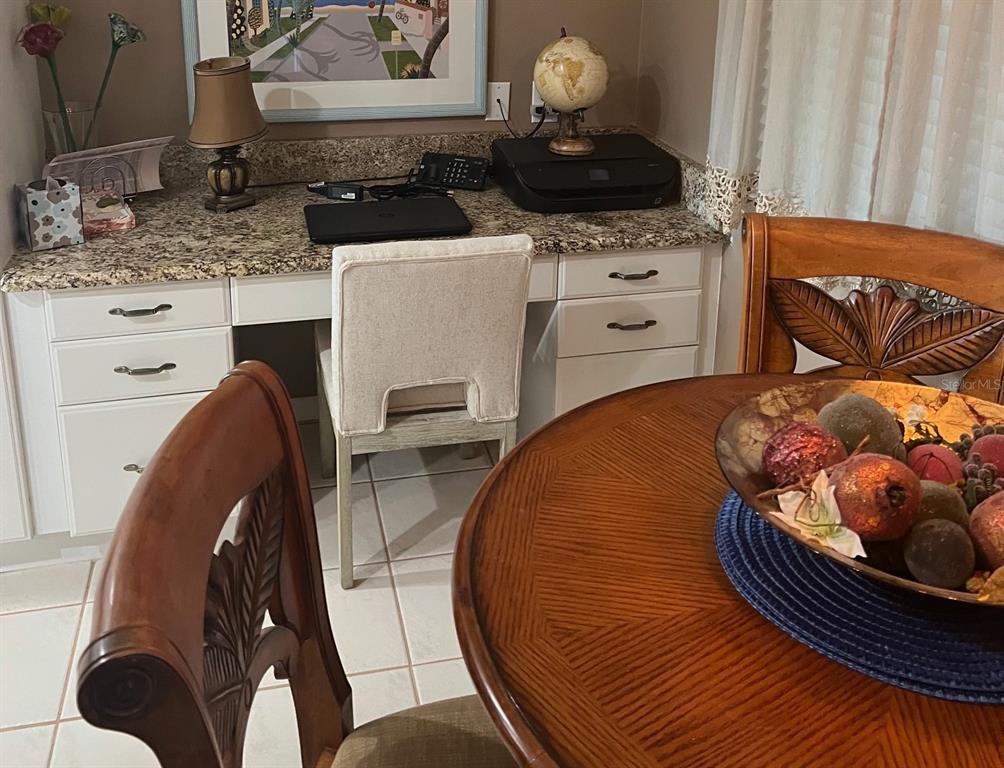 A home office area features a granite countertop desk with white cabinets and a chair — 8750 OLDE HICKORY AVENUE UNIT 9105, SARASOTA, FL