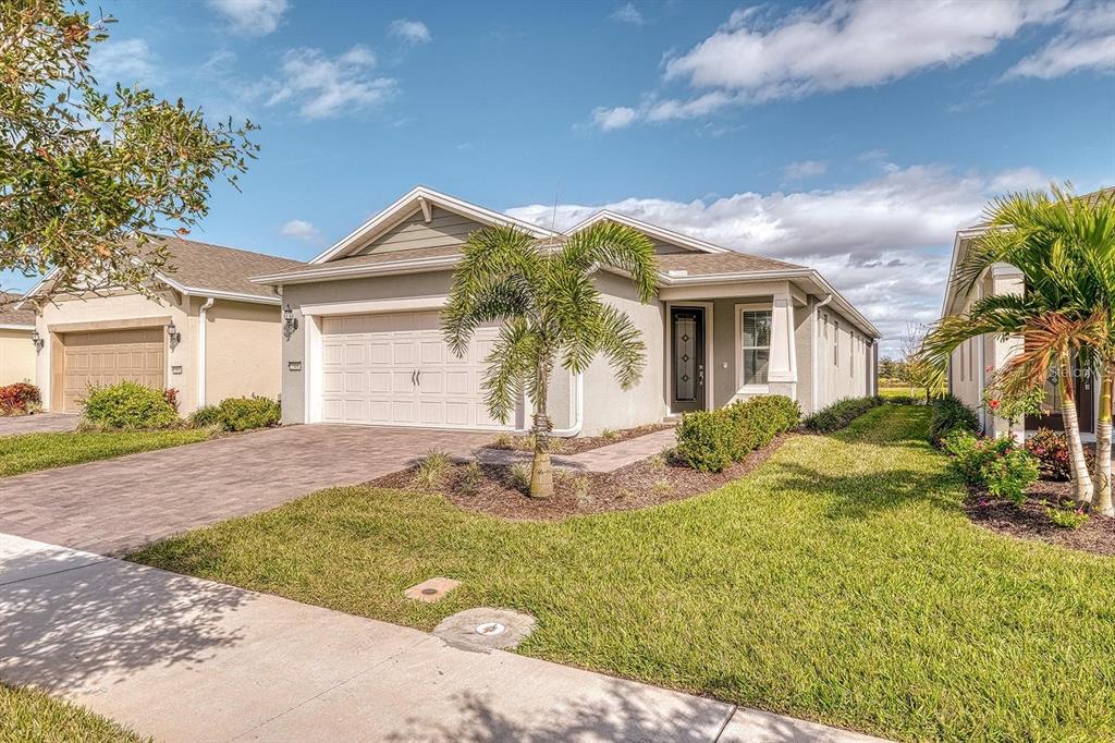 A single-story suburban house with a two-car garage, a palm tree, and a paved driveway — 2505 CLIFF WAY, ST CLOUD, FL