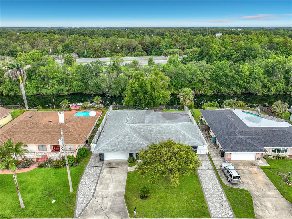 An aerial view shows a residential house with a gray roof between two neighboring homes — 2425 LAUDERDALE COURT, ORLANDO, FL
