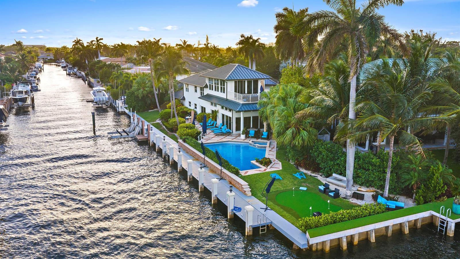 An aerial view of a waterfront house featuring a swimming pool and a putting green — 964 Eve Street, Delray Beach FL 33483, DELRAY BEACH, FL