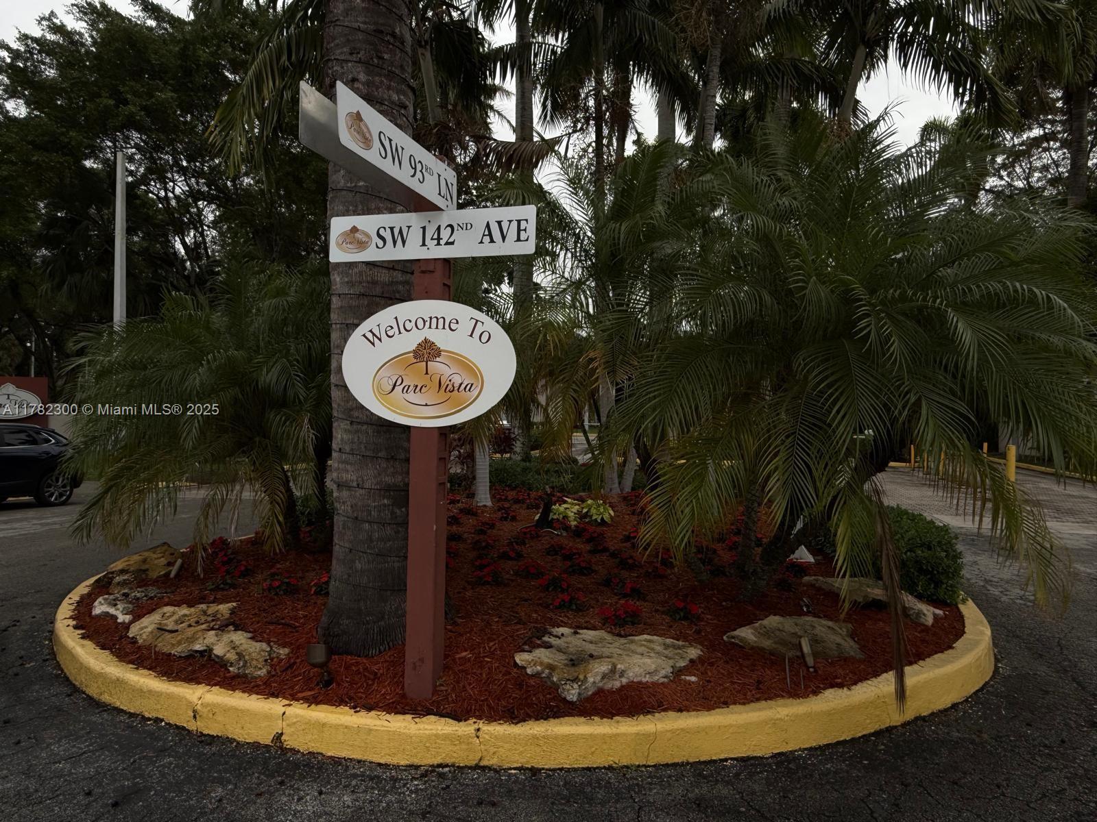 A street sign and welcome sign for Parc Vista stand in a landscaped traffic circle — 9121 SW 138th Pl # 9121, Miami FL 33186, MIAMI, FL