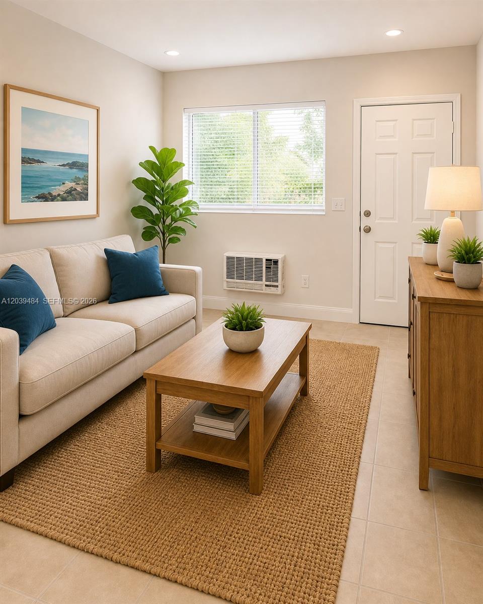 A living room features a beige sofa, wooden coffee table, area rug, and window unit — 223 NW 12th St # 4, Miami FL 33136, MIAMI, FL
