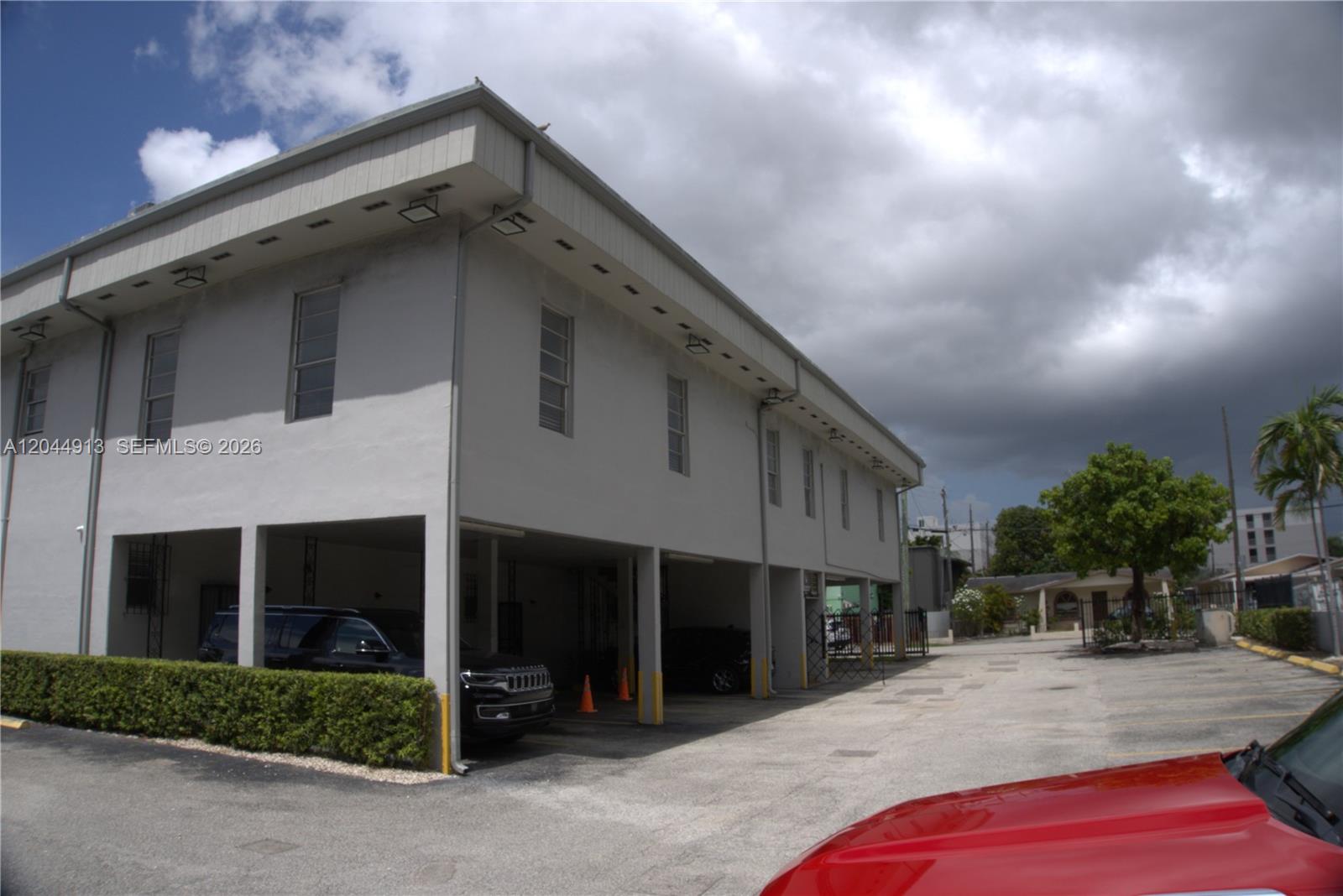 A two-story building with a covered parking area on the ground level — 2433 NW 7th St, Miami FL 33125, MIAMI, FL