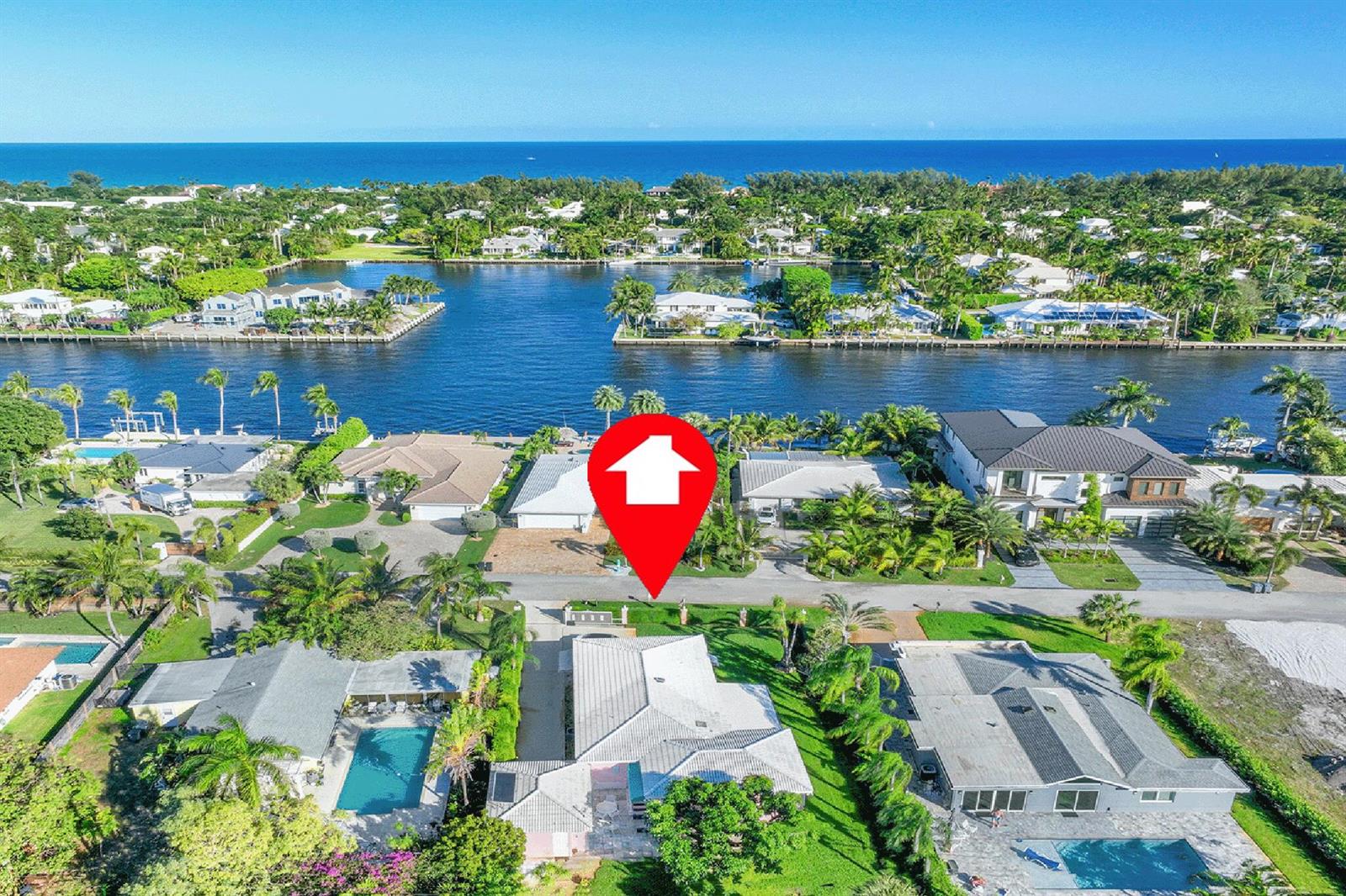 An aerial view shows a residential neighborhood with waterfront homes along a canal — 3216 Karen Drive, Delray Beach FL 33483, DELRAY BEACH, FL