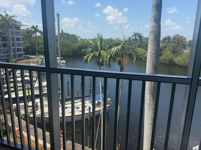 A balcony view overlooks a marina with docked sailboats and palm trees under a blue sky — 1319 E Hillsboro Boulevard # 412, Deerfield Beach FL 33441, DEERFIELD BEACH, FL
