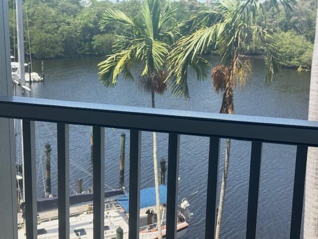 A view from a balcony overlooking a waterway with boats and palm trees — 1319 E Hillsboro Boulevard # 412, Deerfield Beach FL 33441, DEERFIELD BEACH, FL
