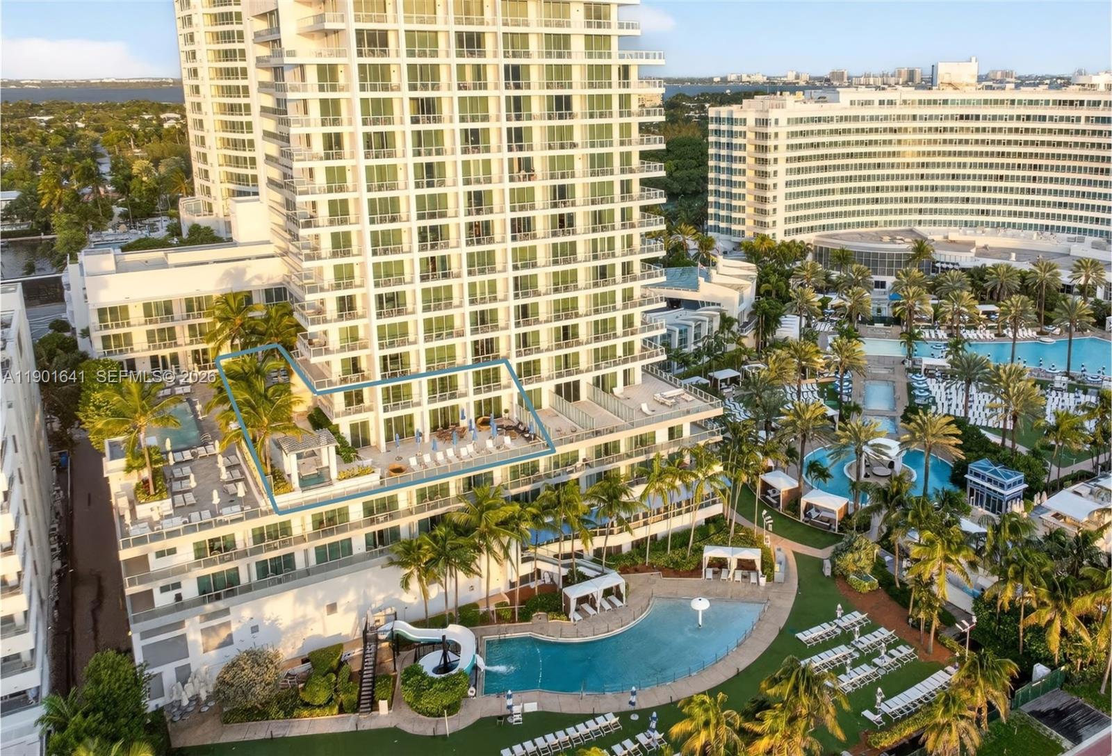 An aerial view shows a high-rise building with a large highlighted terrace and swimming pools — 4391 Collins Ave # 512, Miami Beach FL 33140, MIAMI BEACH, FL