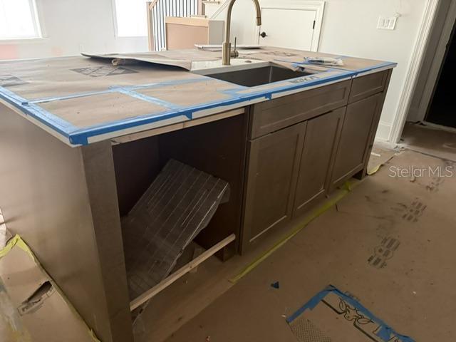 A kitchen features two-toned cabinetry, a large central island, and light-colored wood flooring — 2006 S HABANA AVENUE UNIT 2, TAMPA, FL