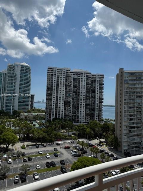 A high-angle view shows a parking lot surrounded by tall residential buildings and water — 2475 Brickell Ave # 1704, Miami FL 33129, MIAMI, FL