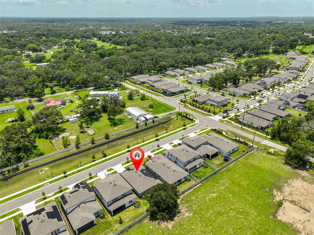An aerial view shows a suburban neighborhood with a red location pin on a house — 2948 FOREST MEADOW AVENUE, VALRICO, FL