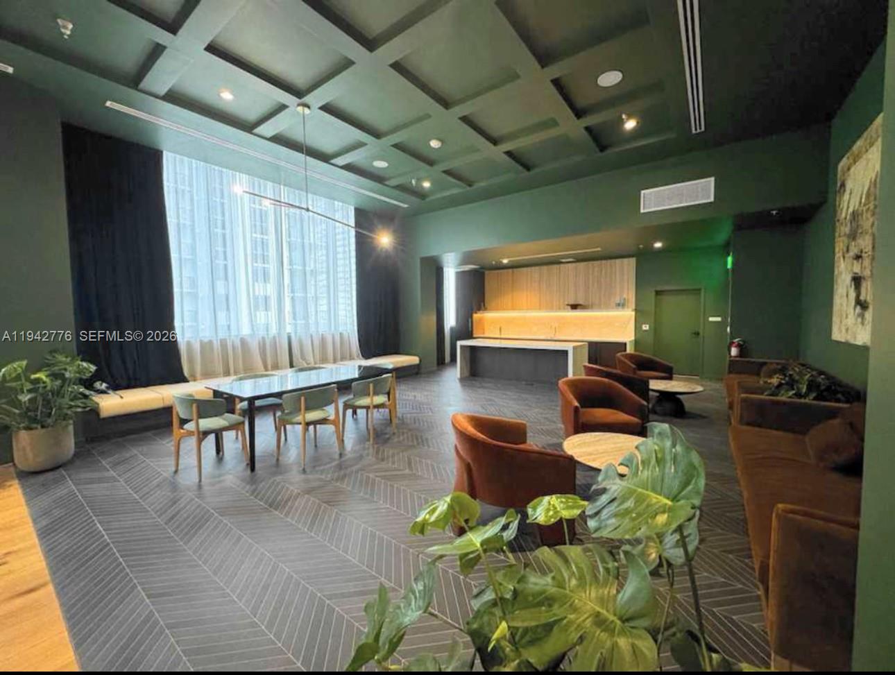 A modern lounge area features dark green walls, a coffered ceiling, and herringbone-patterned flooring — 601 N Miami Ave # 901, Miami FL 33316, MIAMI, FL