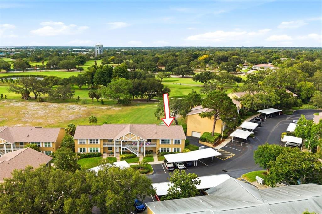 An aerial view shows a two-story apartment building with a red arrow pointing to it — 2240 GULF VIEW BOULEVARD, DUNEDIN, FL