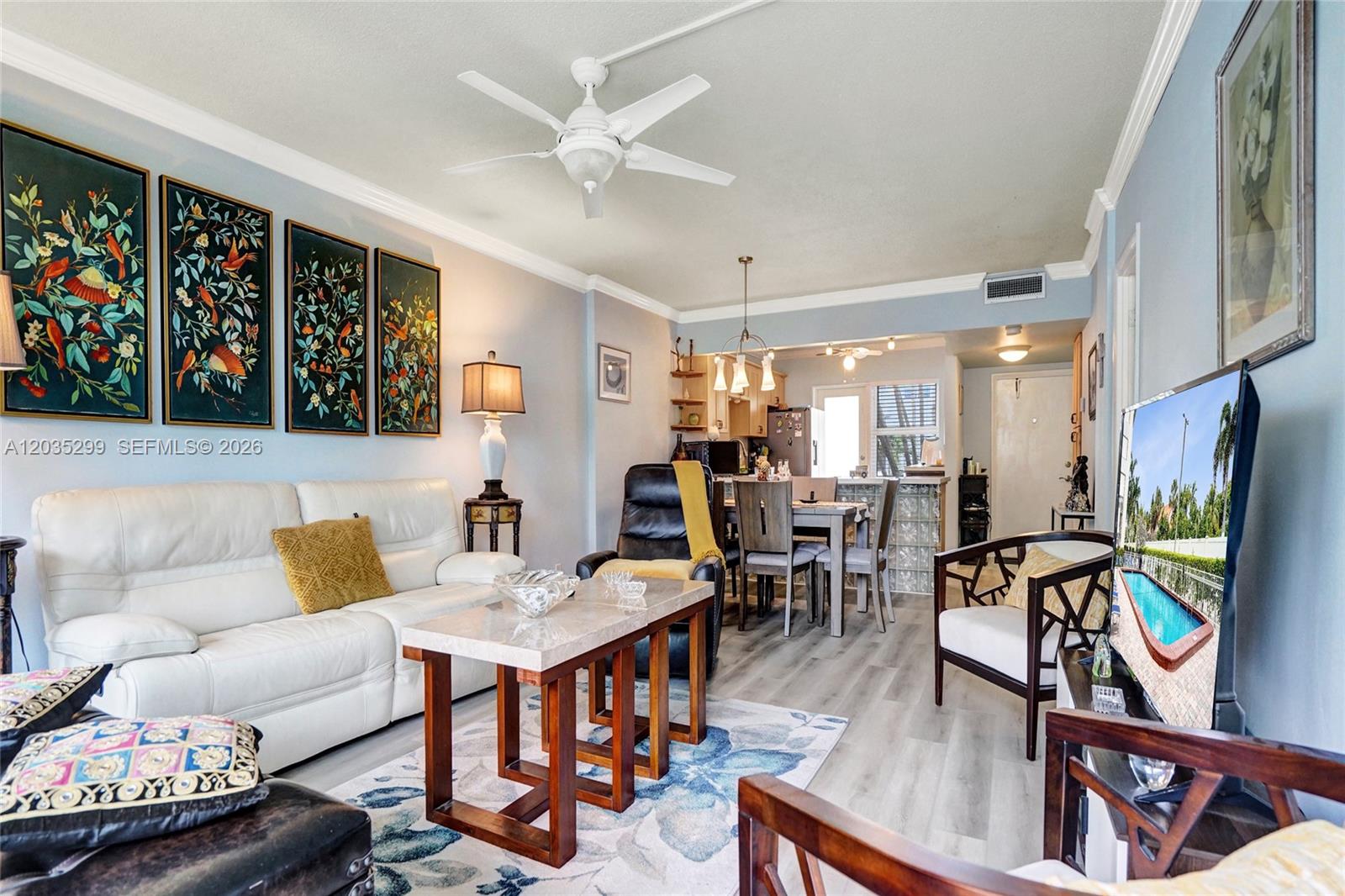 A living room with a white sofa, coffee table, and dining area in the background — 3181 S Ocean Dr # 107, Hallandale Beach FL 33009, HALLANDALE BEACH, FL