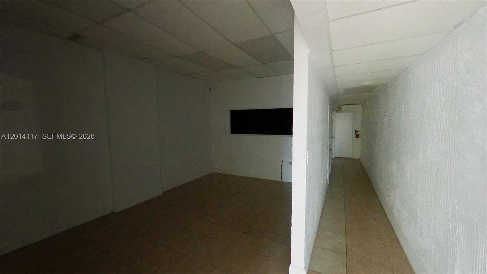 An empty commercial space features white walls, a drop ceiling, and tiled flooring — 2319 NW 7th St # 2319, Miami FL 33125, MIAMI, FL