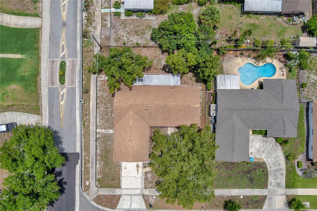 An aerial view shows two adjacent residential houses with driveways and a swimming pool — 4992 E WIND STREET, ORLANDO, FL