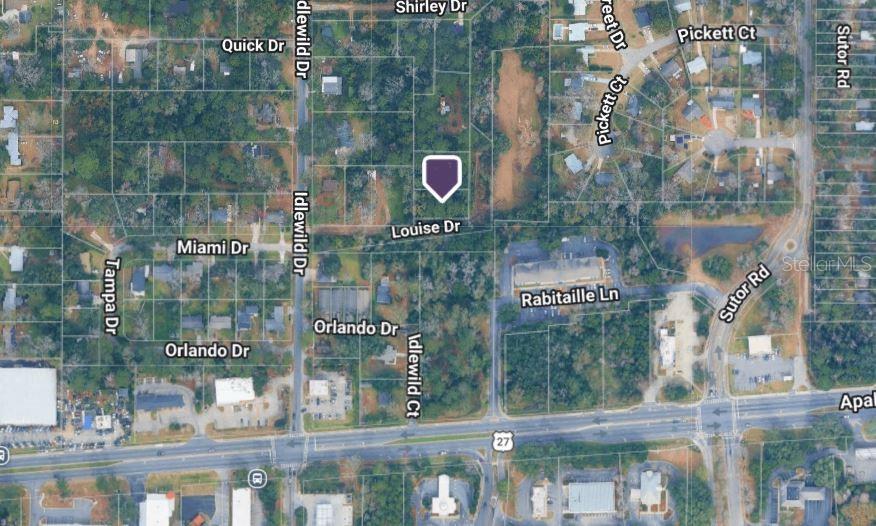 This is an aerial map showing a vacant lot marked with a pin near residential streets — PICHARD DRIVE, TALLAHASSEE, FL