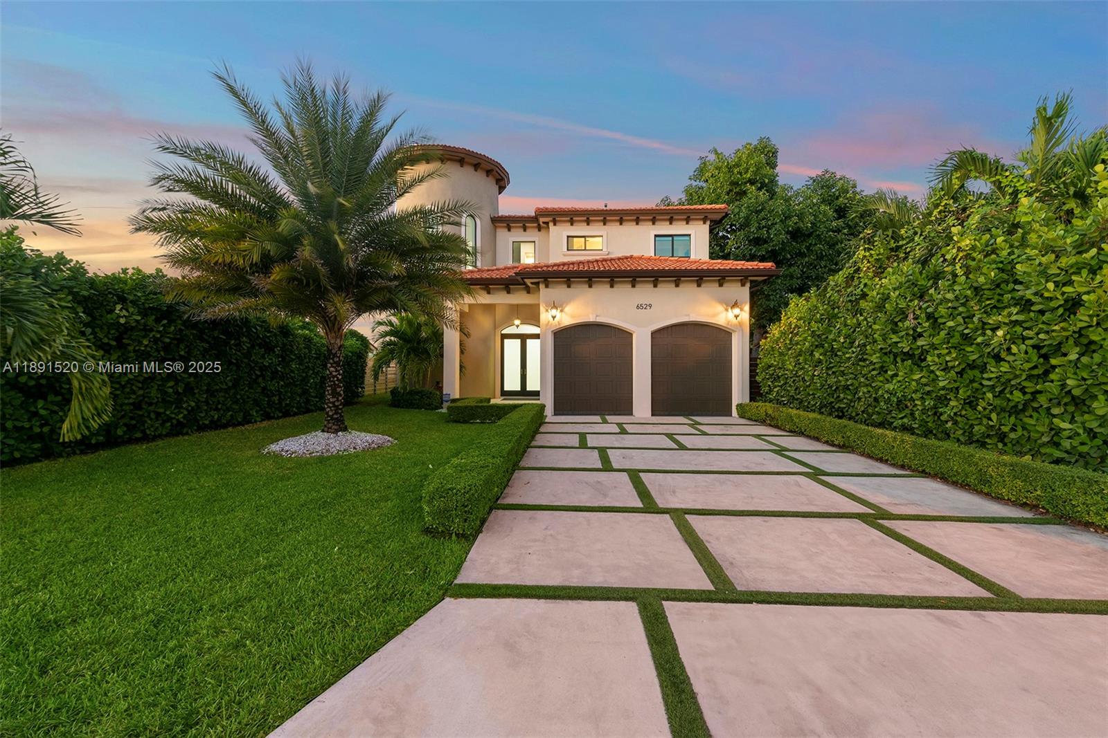 A two-story stucco house with a tile roof and a paved driveway sits behind hedges — 6529 SW 30th St, Miami FL 33155, MIAMI, FL