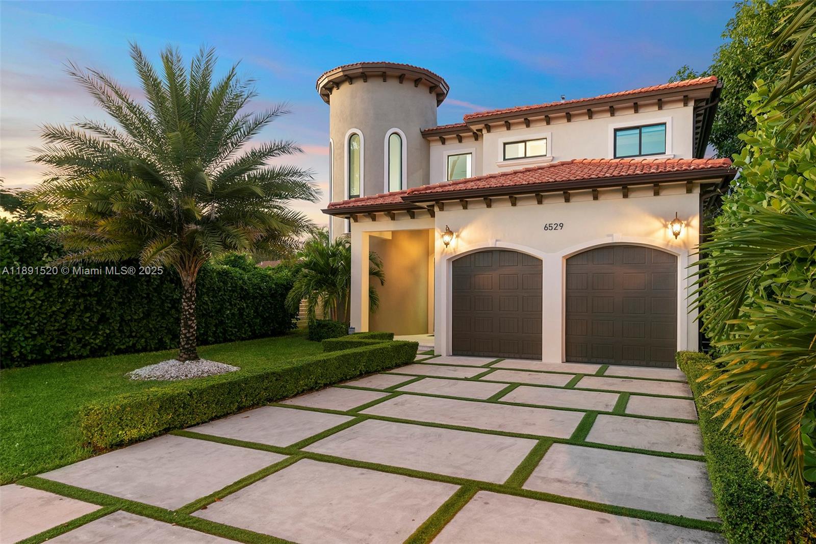 A two-story house with a turret, a two-car garage, and a paved driveway with grass — 6529 SW 30th St, Miami FL 33155, MIAMI, FL