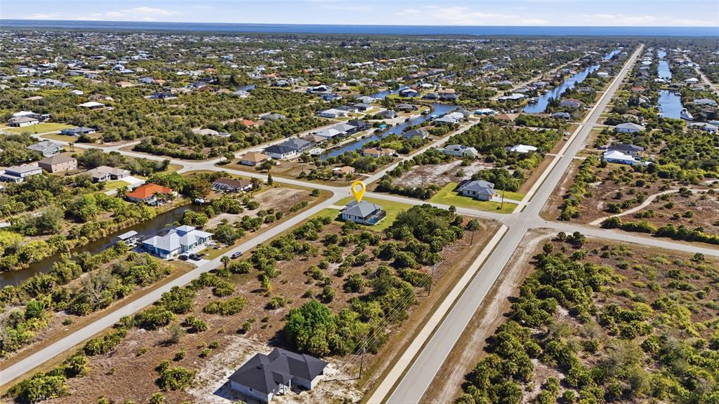 An aerial view shows a house with a yellow location pin in a suburban neighborhood — 14361 FORT MYERS AVENUE, PORT CHARLOTTE, FL