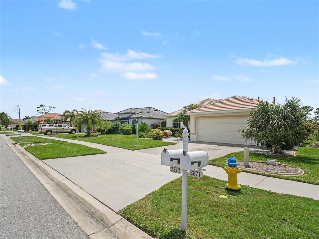 A street view of suburban houses with a fire hydrant and mailboxes in the foreground — 2885 ROYAL PALM DRIVE, NORTH PORT, FL